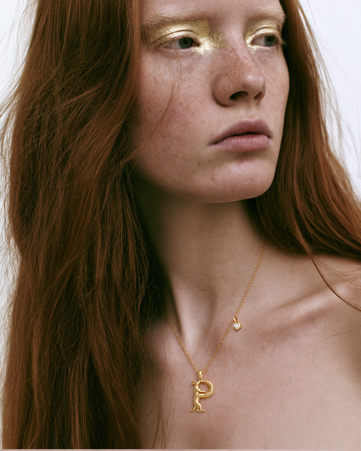 Model wearing the gold P initial necklace
