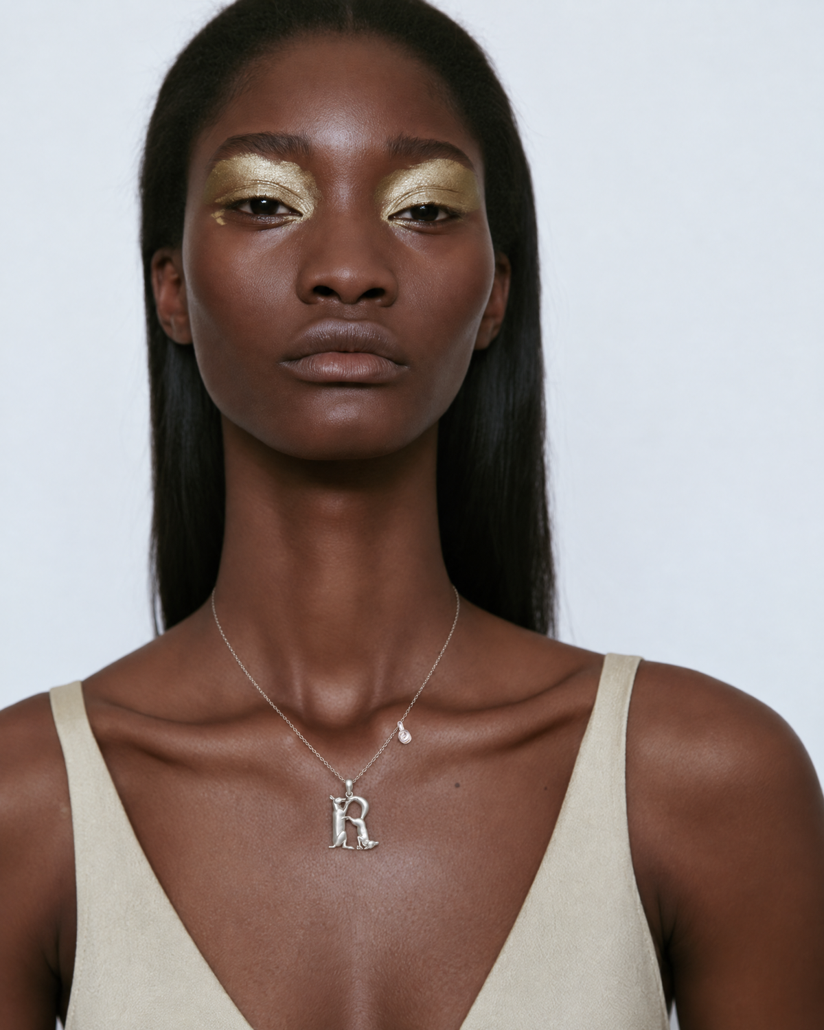 Model wearing the gold R initial necklace