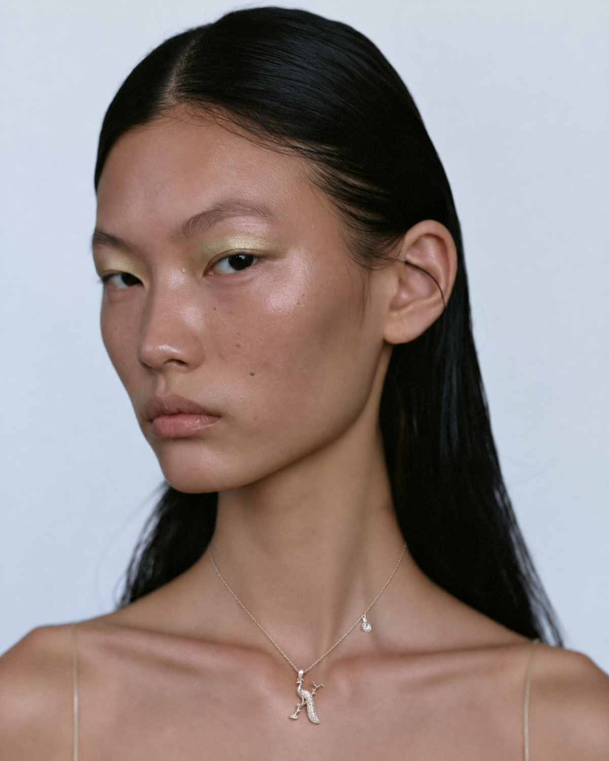Model wearing the gold X initial necklace