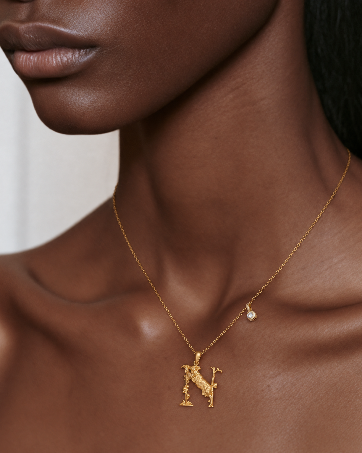Model wearing the gold N initial necklace