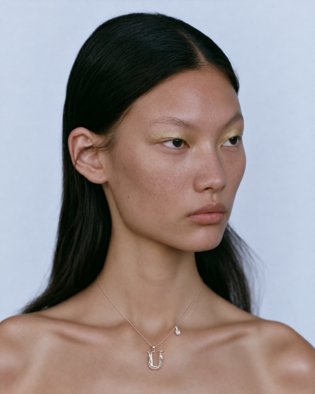 Model wearing the gold U initial necklace